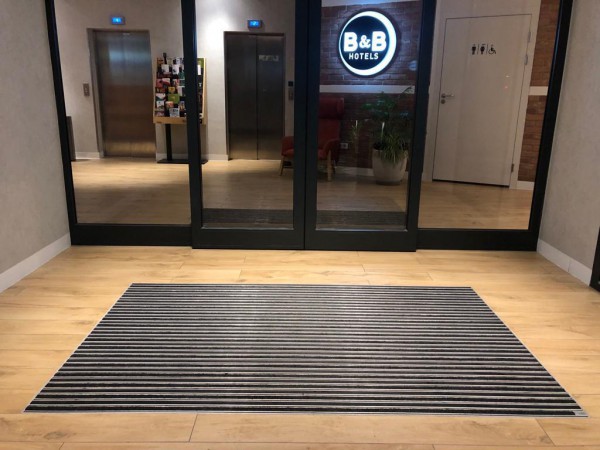 Floor mat embedded in the floor indoors